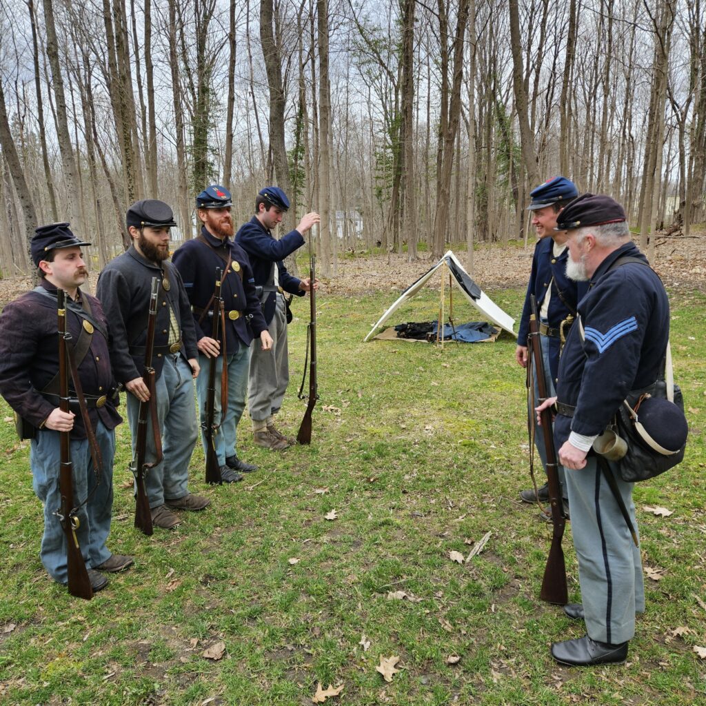 A group of men wearing blue uniforms and flat caps.