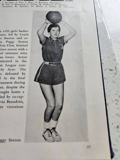 A picture of high-school aged Peggy ready to shoot a basketball wearing a 1950’s basketball uniform. 