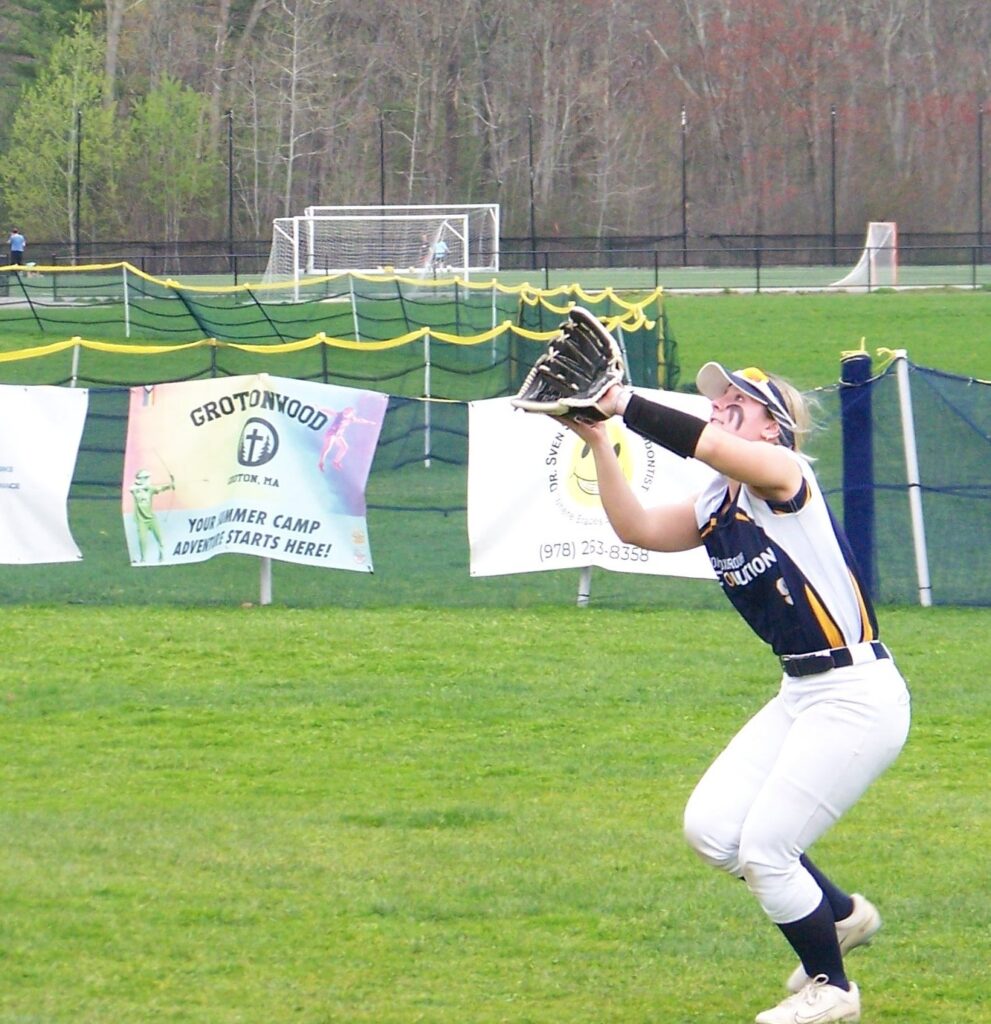 A Revs player prepares to catch an incoming fly ball.