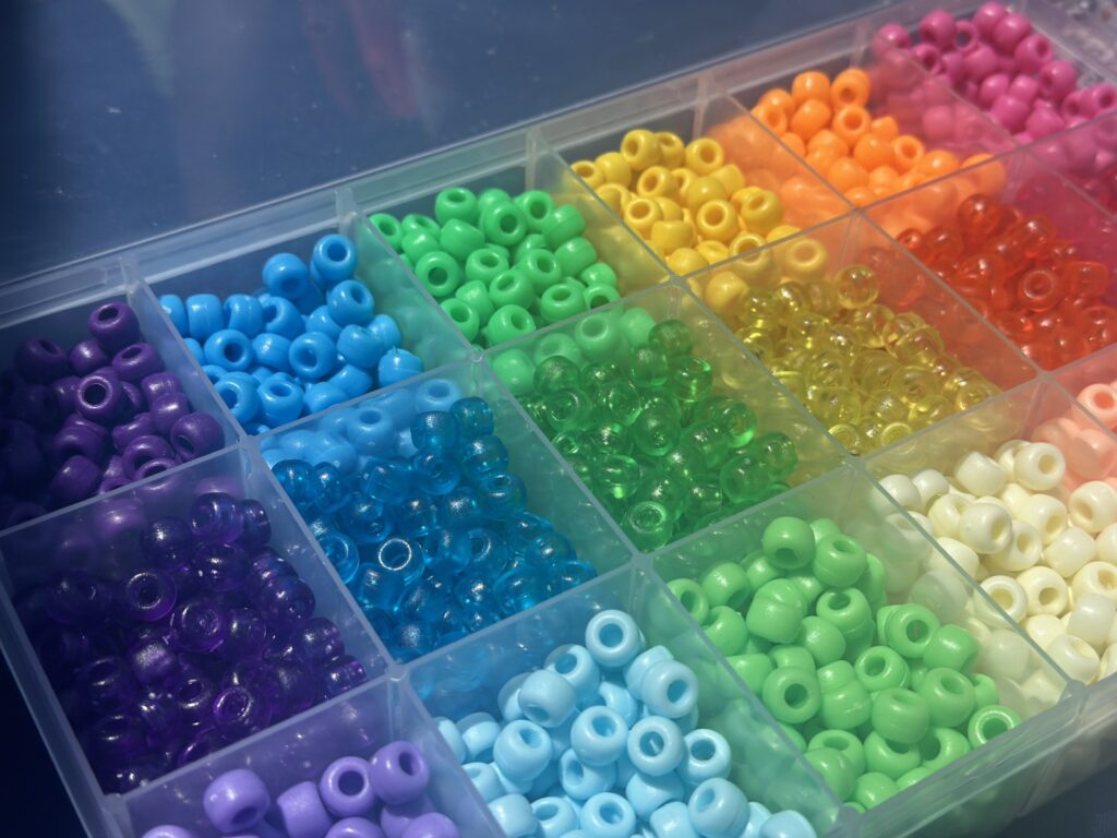A box of bead in a rainbow of colors.