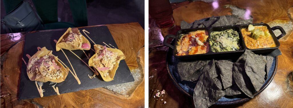 On the left, a piece of slate with tthree corn tortillas shaped into bowls that are filled with something. On the right, a cast iron platter with blue corn chips and three small bowls with different dips.
