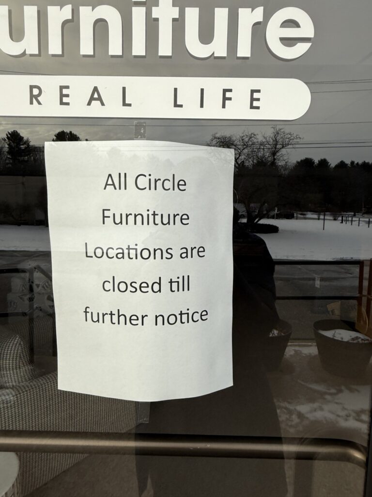 A sign taped up on the door -- All Circle Furniture Locations (sic) are closed till (sic) further notice