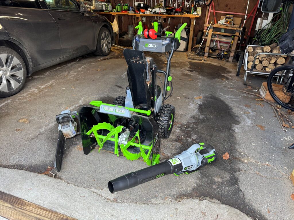 An open garage showing off a variety of electric power tools.