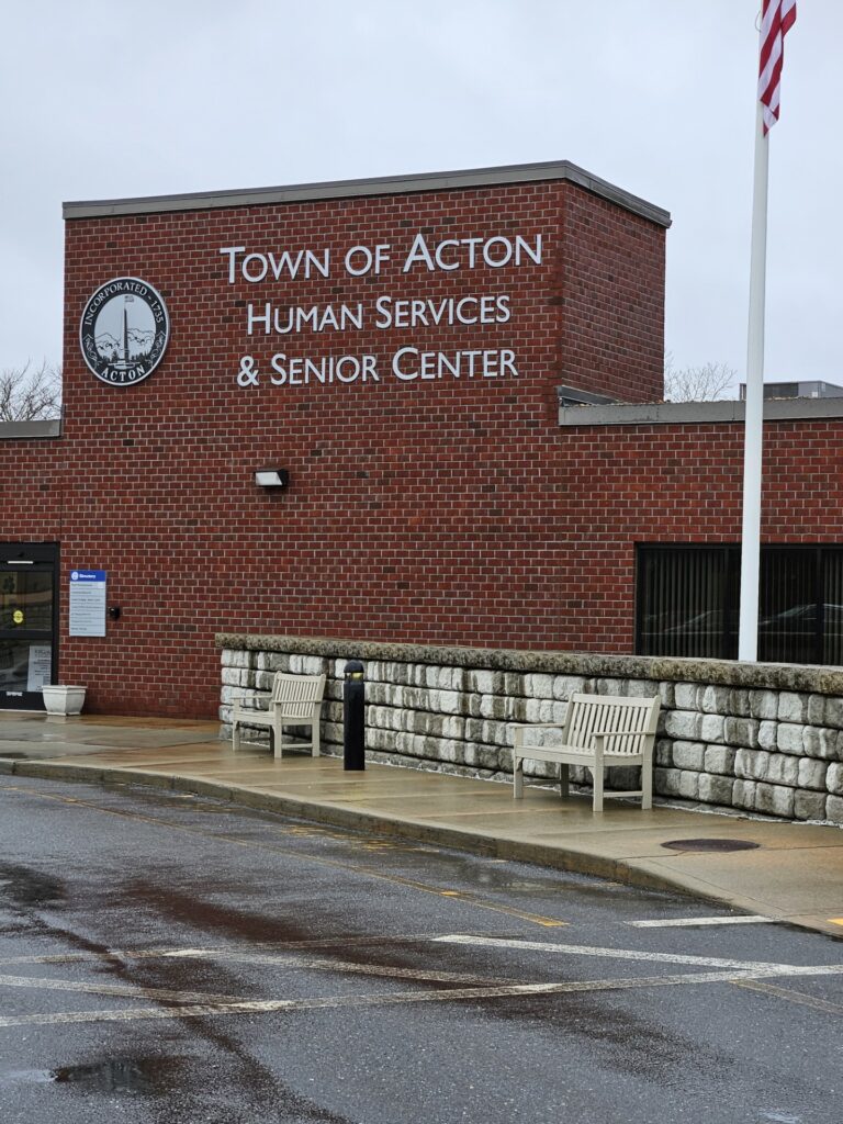 A brick building with the words "Town of Acton Human Services & Senior Center."