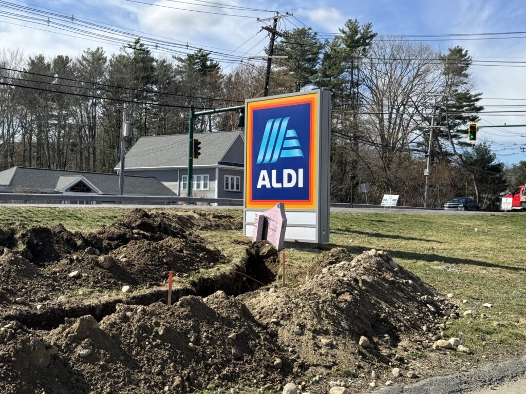 A sign with the blue and orange Aldi logo is now on the corner of Rt. 62 and High Street.