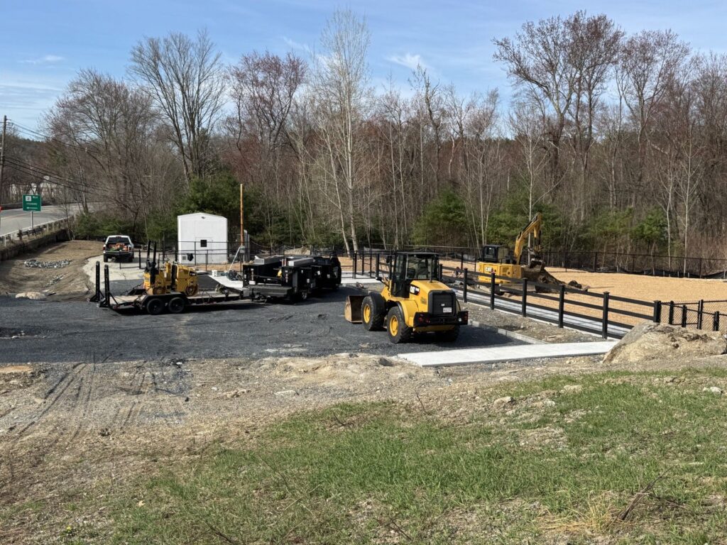 Fencing, sidewalks, and construction vehicles,.It doesn't quite look like a dog park, yet.