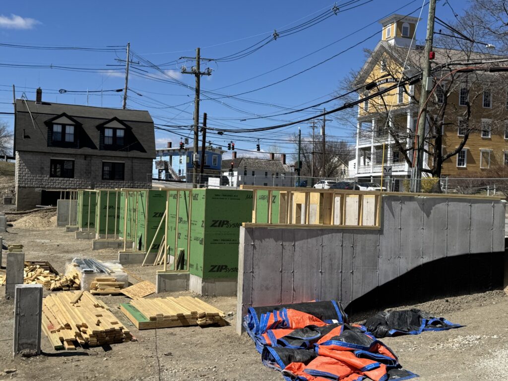 A concrete wall, Tyvek covered structurs and lumber. It's a building in progress.