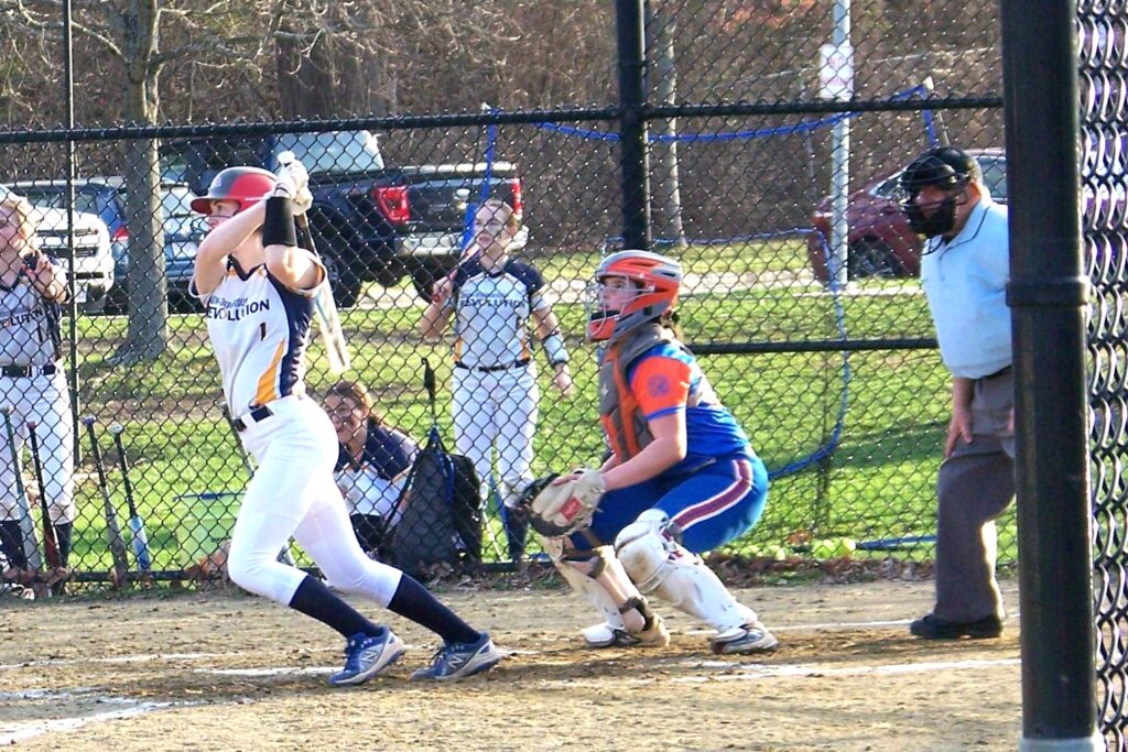 An AB player finishes up a strong hit at the ball.