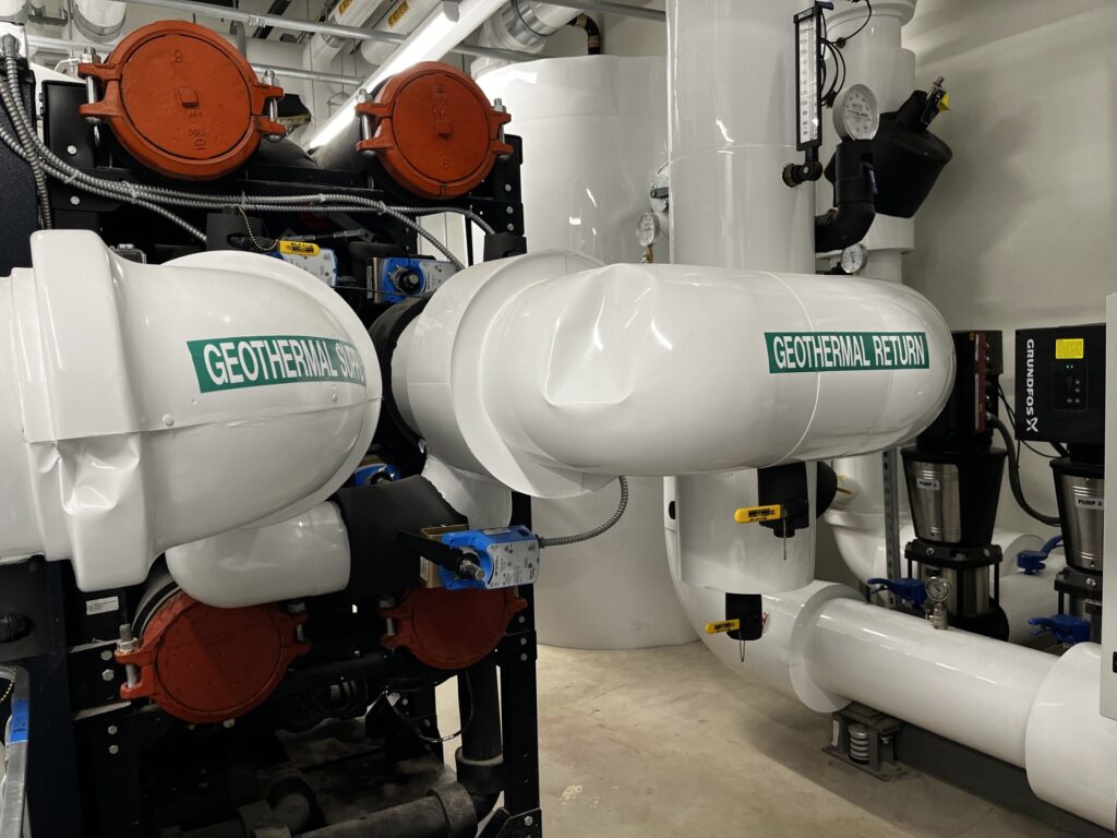 Large white pipes and other equipment in a room.