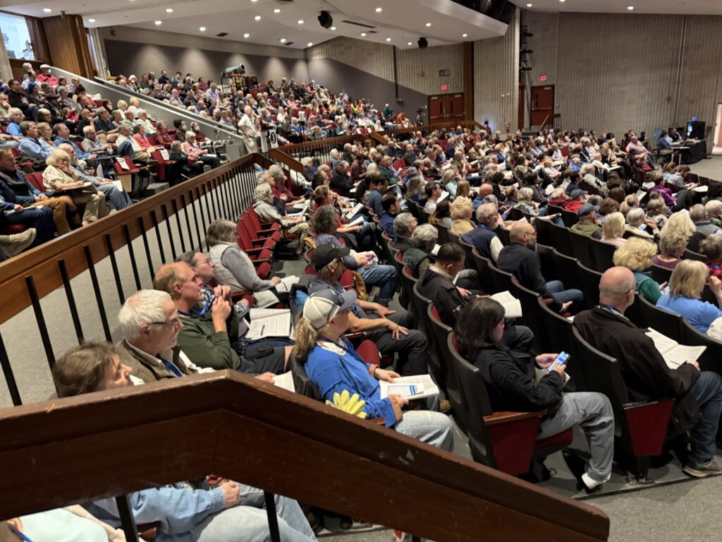 The high school auditorium is fairly full on the first night of Town Meeting.