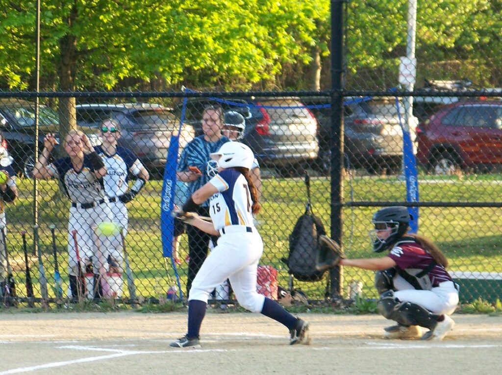 An AB player gives the ball a good whack. The ball is leaving the bat at waist height.