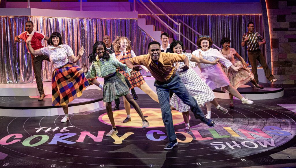 A racially mixed group of kids dance onstage.