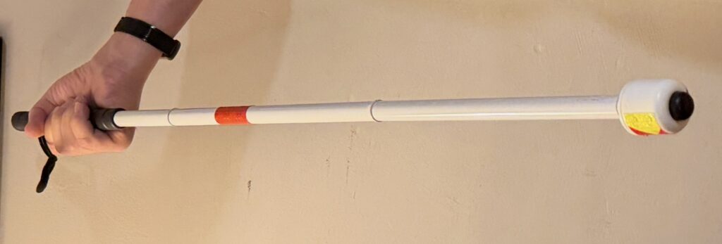 A white cane with a special tip that provides extra stability.