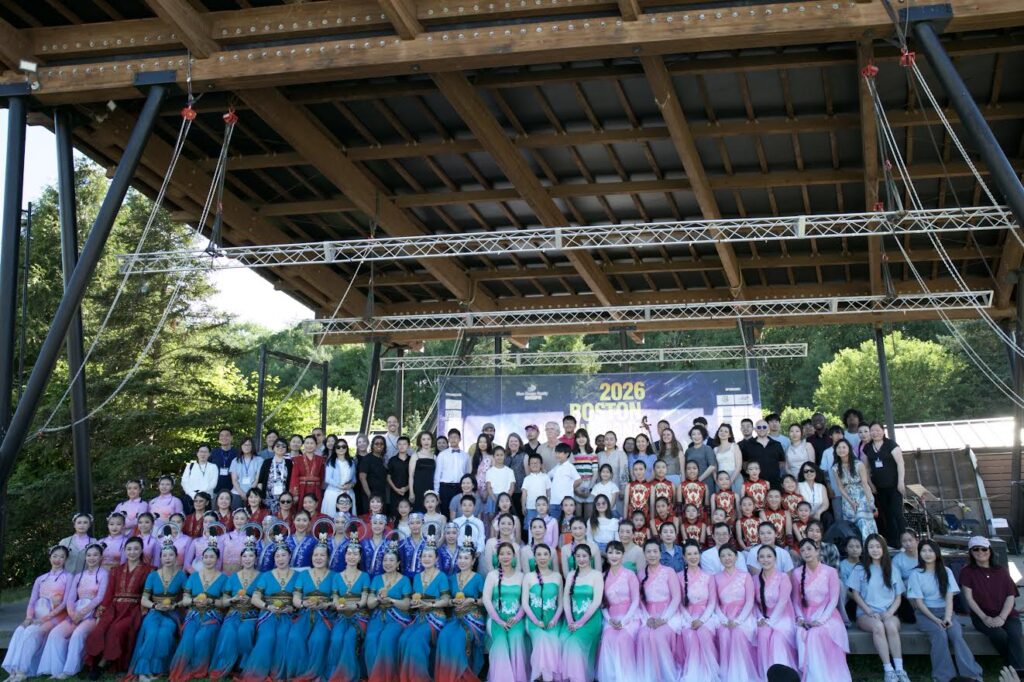All of the people who performed, spoke, or helped run the music festival fill the outdoor stage.